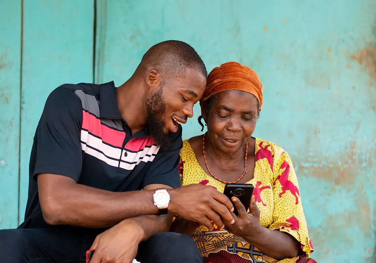 African american men and woman sitting and watching at phone